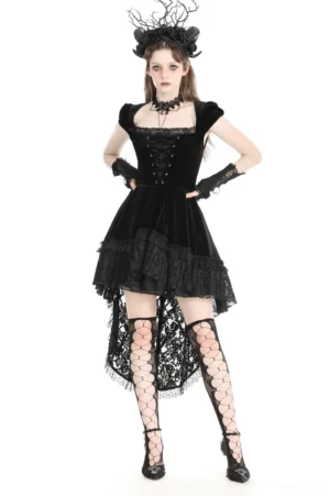 Black velvet swallowtail gothic dress with lace corset front, cap sleeves, and dramatic high-low ruffled hem - front three-quarter view on model with gothic antler headdress