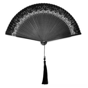 Flat lay view of black gothic folding hand fan with silver trim and long black skull tassel, Victorian lace detail visible