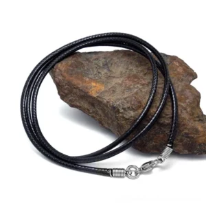 Black wax rope gothic necklace with stainless steel clasp, detailed oblique view on textured stone background showing braided cord texture