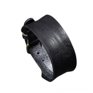 Black wide leather gothic bracelet with adjustable metal buckle, matte cowhide texture side view