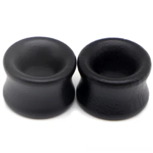 Gothic tunnel ear expanders showing matte black finish and hollow structure detail from side angle
