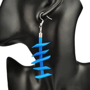Blue twisted spike rubber dangle earrings gothic punk jewelry worn on black mannequin ear model close-up right side