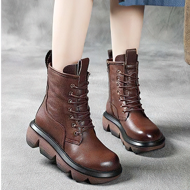 Brown gothic platform combat boots pair three-quarter view, durable lug sole and polished leather