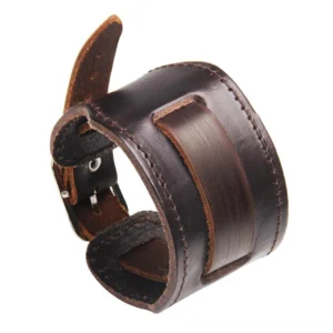Wide brown genuine leather gothic bracelet with stainless steel buckle, featuring decorative panel and hand-stitched seams, displayed on white background