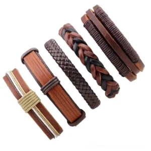 Five assorted brown leather wristbands arranged flat lay, displaying rock style mixed design aesthetic with braided and simple textures