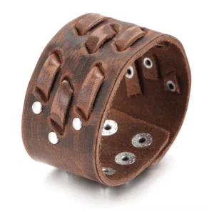 Distressed brown leather gothic cuff bracelet with metal rivets, full view on white background showing wide design and cutout patterns