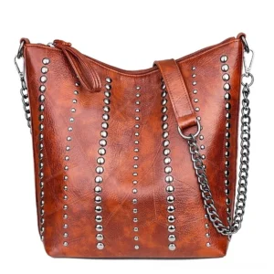 Brown vintage rivet bucket crossbody bag with distressed PU leather and chain strap, alternative fashion style