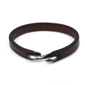 Weathered brown distressed leather gothic bracelet with antique copper alloy hardware, flat lay