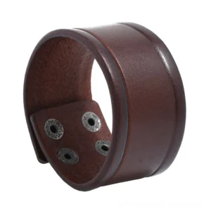 Brown vintage genuine leather wide cuff bracelet with adjustable snap fasteners, studio oblique view