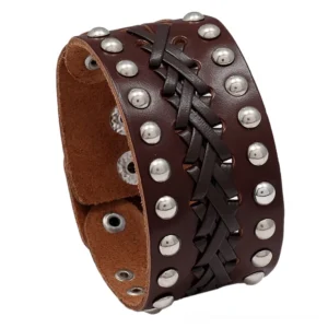 Brown leather braided studded gothic cuff bracelet with silver metal rivets on white background, artisan weave detail