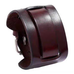 Burgundy brown cowhide leather wide cuff bracelet with textured surface and metal closure, 3/4 side view