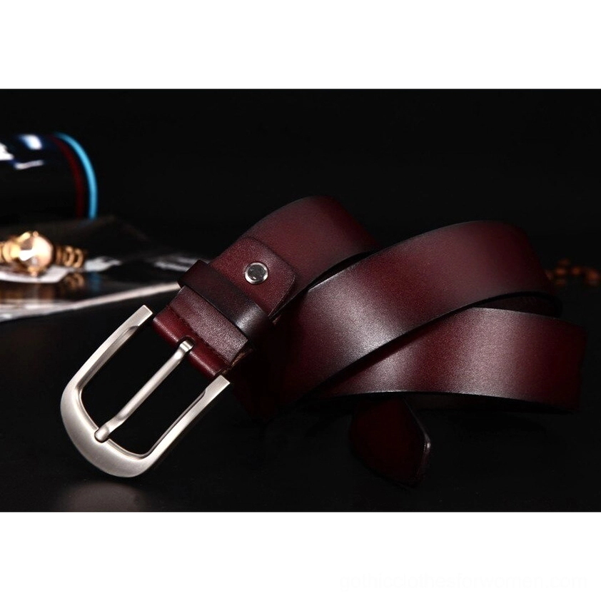 Wine red leather gothic belt with silver pin buckle, 3/4 side angle showing fastener rivet and material sheen