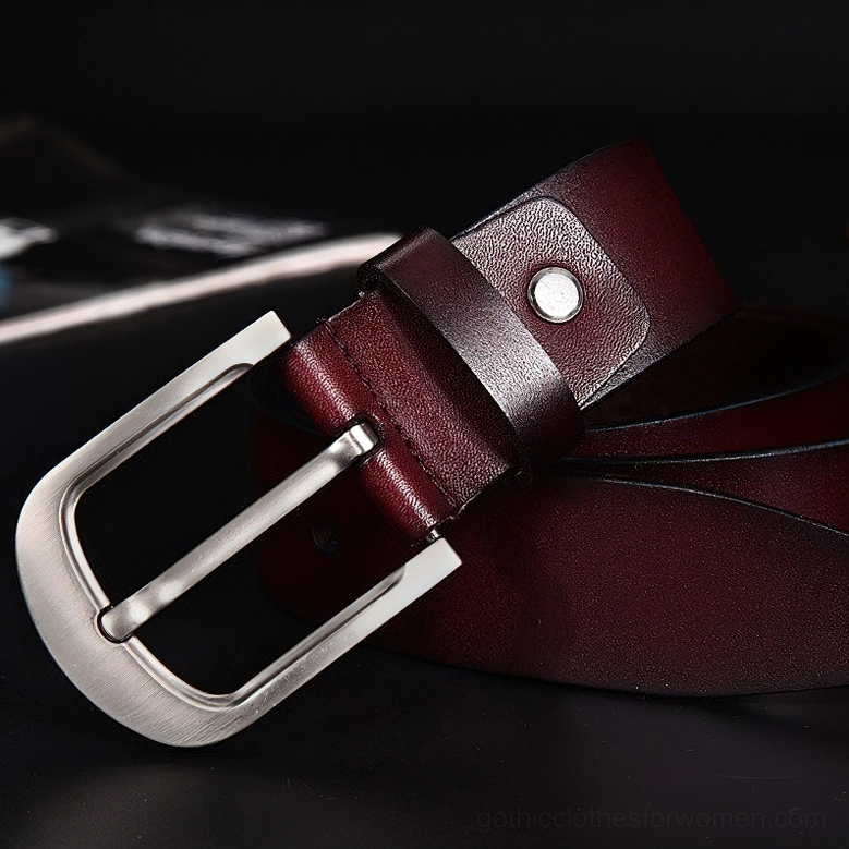 Wine red glossy cowskin gothic belt with wide silver pin buckle, 3/4 front side view on dark background