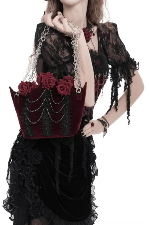 Burgundy gothic rose handbag three-quarter front view on model in dark lace dress, featuring silver chain shoulder straps and sculpted roses
