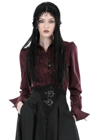Burgundy Victorian gothic ruffled blouse front three-quarter view on model with black braided hair, styled with high-waisted black skirt