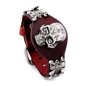 Dark burgundy genuine leather skull cuff bracelet with antique silver buckle and side trim details, top-down view
