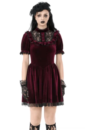 Front view of burgundy velvet gothic mini dress with black lace yoke, puff sleeves, and high stand collar worn by goth model