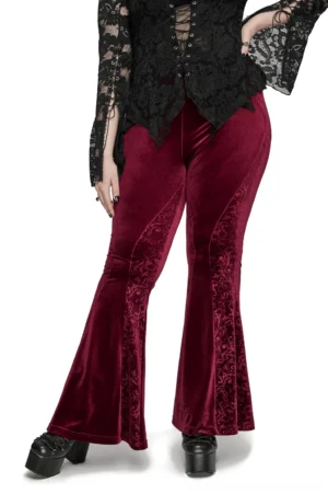 Burgundy velvet flared gothic pants three-quarter front view showing embossed scroll details and hourglass silhouette