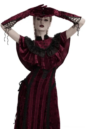 close-up of burgundy velvet opera gloves featuring black lace wrist detail on model with hands posed over forehead