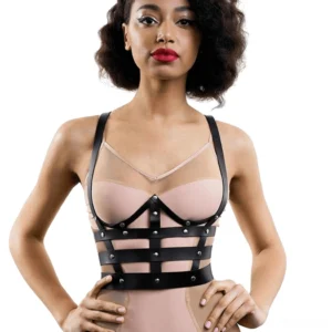 Cage-style leather chest harness front view with metal studs and geometric grid pattern design