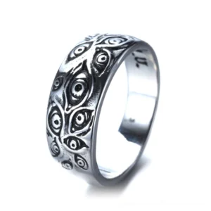 Carved eyes gothic ring vintage punk band oblique side view showing intricate engraved eye patterns and silver-toned zinc alloy material with inner letter marking