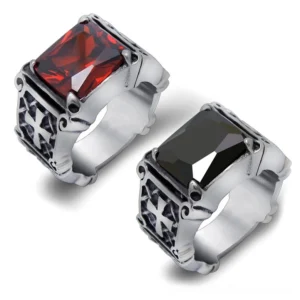 Celtic cross gothic rings with semi-precious stones in black and red, stainless steel, top-down flat lay view