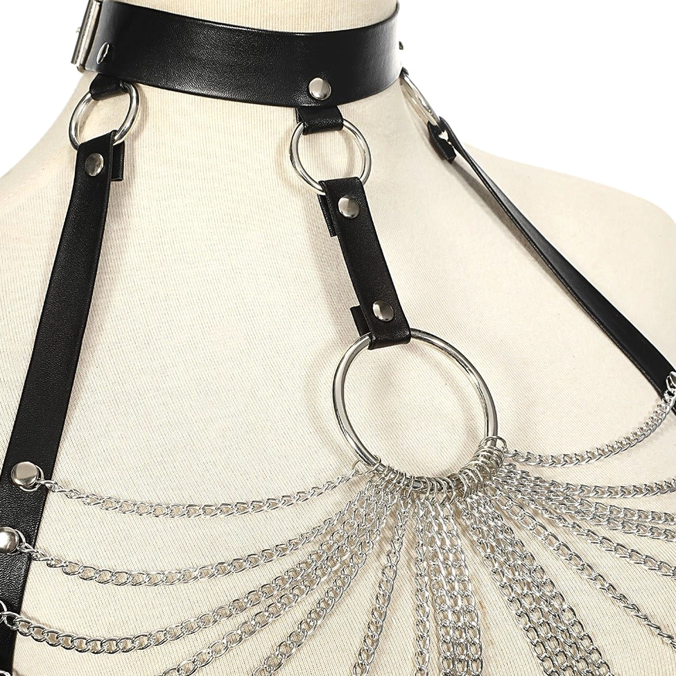Close-up detail of black leather chest harness showing metal chain craftsmanship and ring components