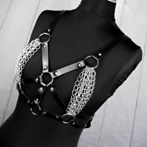 Gothic BDSM body harness on mannequin, front facing, featuring silver metal chain accents and adjustable leather straps