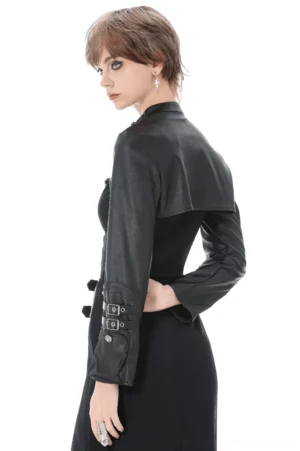 Black faux leather cropped cape with stand collar and cuff buckles, side profile showing sleeve detail