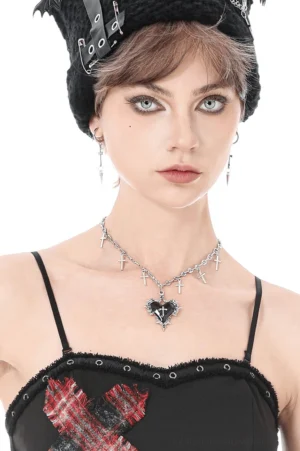 Female model wearing silver cross charm gothic choker necklace with black heart pendant and tiny cross charms