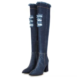 Dark blue denim over-the-knee high heel boots with strategic torn patches and frayed top collar, front view