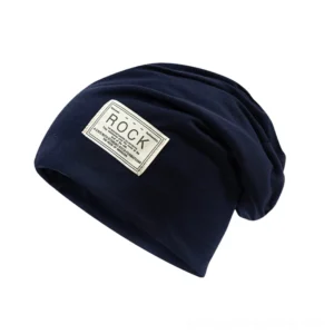 Navy blue dark gothic slouch beanie with ROCK woven label, three-quarter angle studio shot