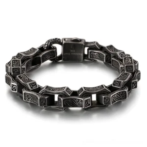 Dark gray gothic engraved square link stainless steel cuff bracelet overhead flat lay view with antique silver finish