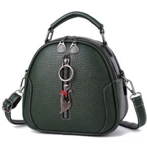 Dark green gothic crossbody handbag with cat pendant, front flat view displaying structured shell design