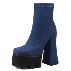 Blue denim gothic platform ankle boots with black serrated platform sole and flared block heel, front three-quarter angle