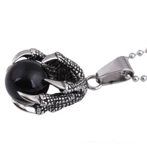 Dragon claw pendant side profile showing intricate stainless steel claw texture and black crystal setting