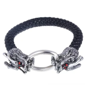 Dragon head gothic leather bracelet with silver metal clasp and red gem eyes shown in studio flat lay