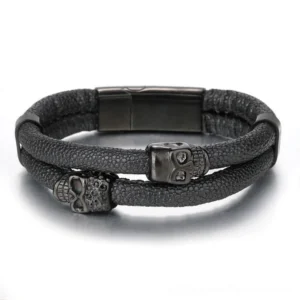 Top-down flat view of black leather skull bracelet showing dual-strand construction and black stainless steel magnetic buckle