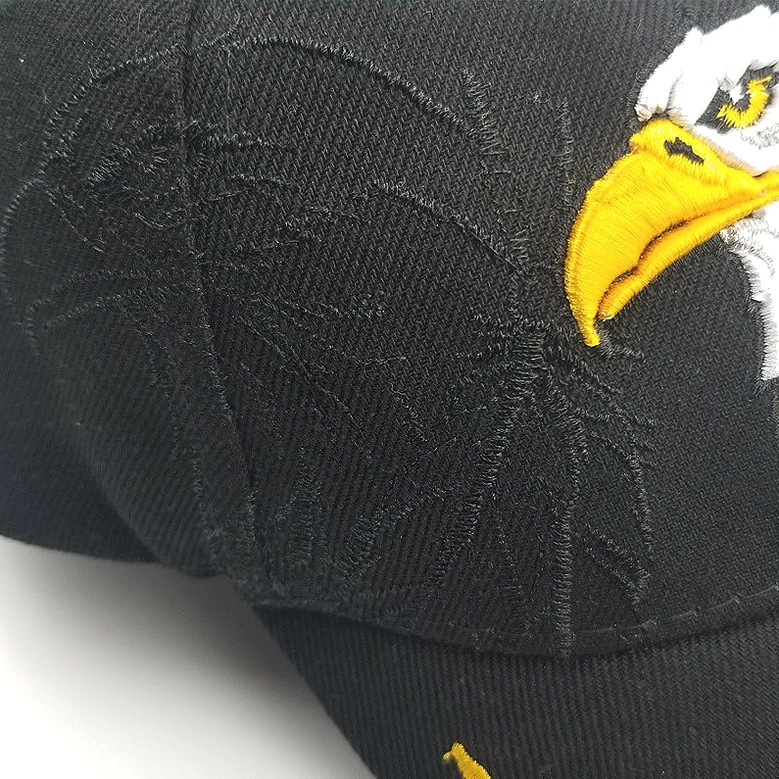 Close-up macro detail of bald eagle embroidery on gothic black cotton baseball cap