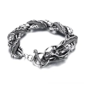 Embossed dragon link bracelet flat lay overhead view, showing detailed scaled dragon head and interlocking chain segments in antiqued stainless steel