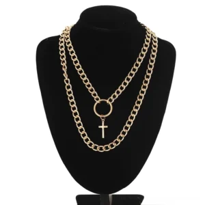 Gold-toned layered cross chain necklace with circle connector and cross charm on black jewelry mannequin front display