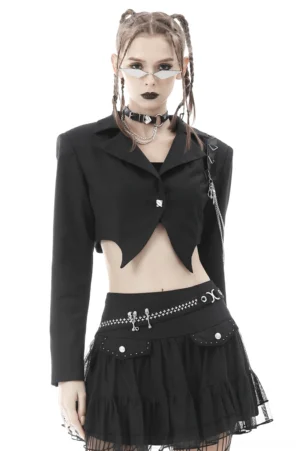 Black cropped goth jacket with chain embellishments and skull hardware, front view on model with braided hair
