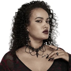 Black lace bird skull choker necklace worn by goth model with dark makeup, front close-up view