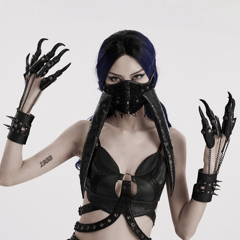 Female goth model wearing black spiked claw gloves with chains and black cut-out top