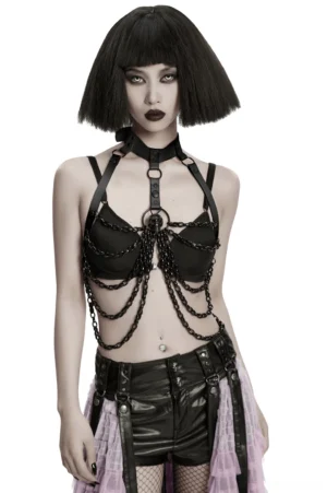 Female goth model wearing black gothic skull chain chest harness with detachable bow, front torso view showcasing leather construction and metal chain details