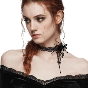 Black gothic lace choker with blood drop accents shown from side angle on red-haired model with smoky goth makeup