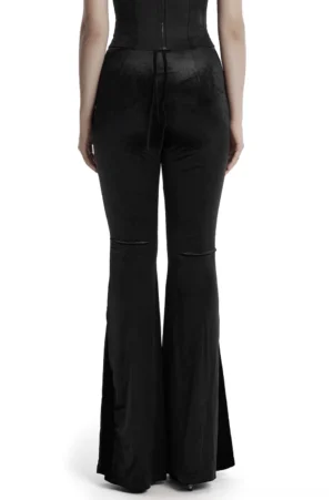 Gothic velvet pants rear view on mannequin displaying back waist tie strap, flared hem, and knee seam details in black velvet fabric