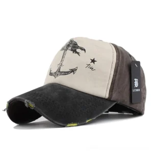 Black and brown distressed gothic anchor baseball cap with color-blocked design and frayed brim edges, front three-quarter view