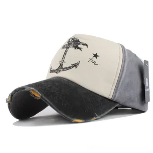 Black and gray monochromatic distressed snapback cap with ship anchor print and worn edges, three-quarter angle