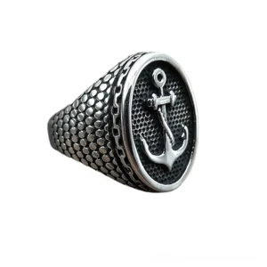 Blackened anchor signet ring side profile showing embossed anchor detail and scale-patterned ring body, right side view